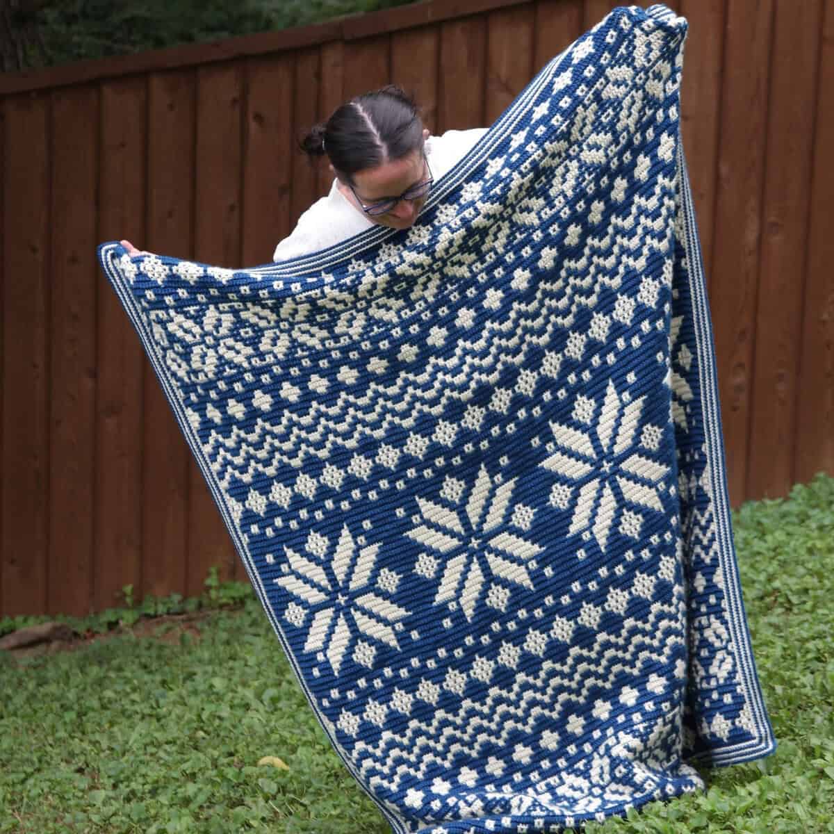Handcrafted blue and white mosaic crochet blanket with snowflake pattern by Juniper and Oakes.